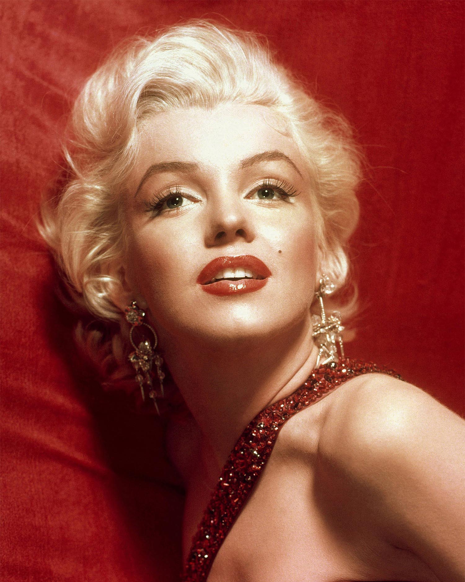 A glamorous Marilyn Monroe in a red dress.